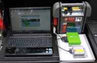 Showing the process of downloading crash data from a vehicle black box recorder.