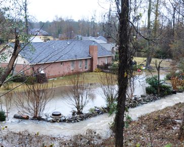 Flooding can occur with houses built on the bottom of a hill such as this example.  Common drainage problems loften need the expert advice of Atlanta Civil Engineering.